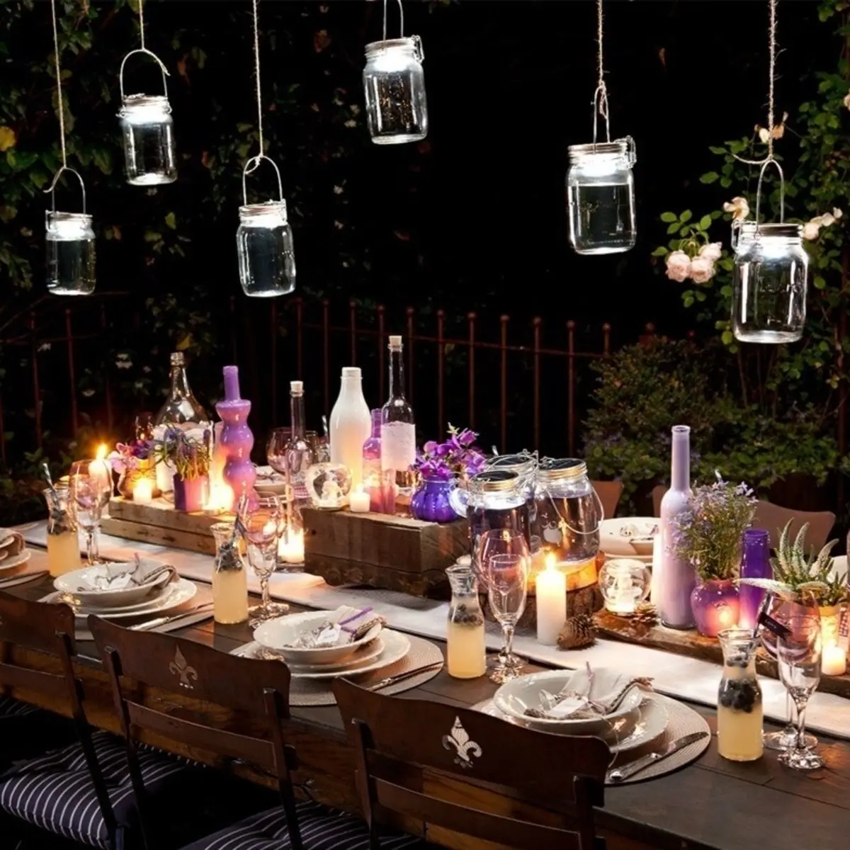 Ramadan table decorations with decorative candles, jars, and hanging lights.