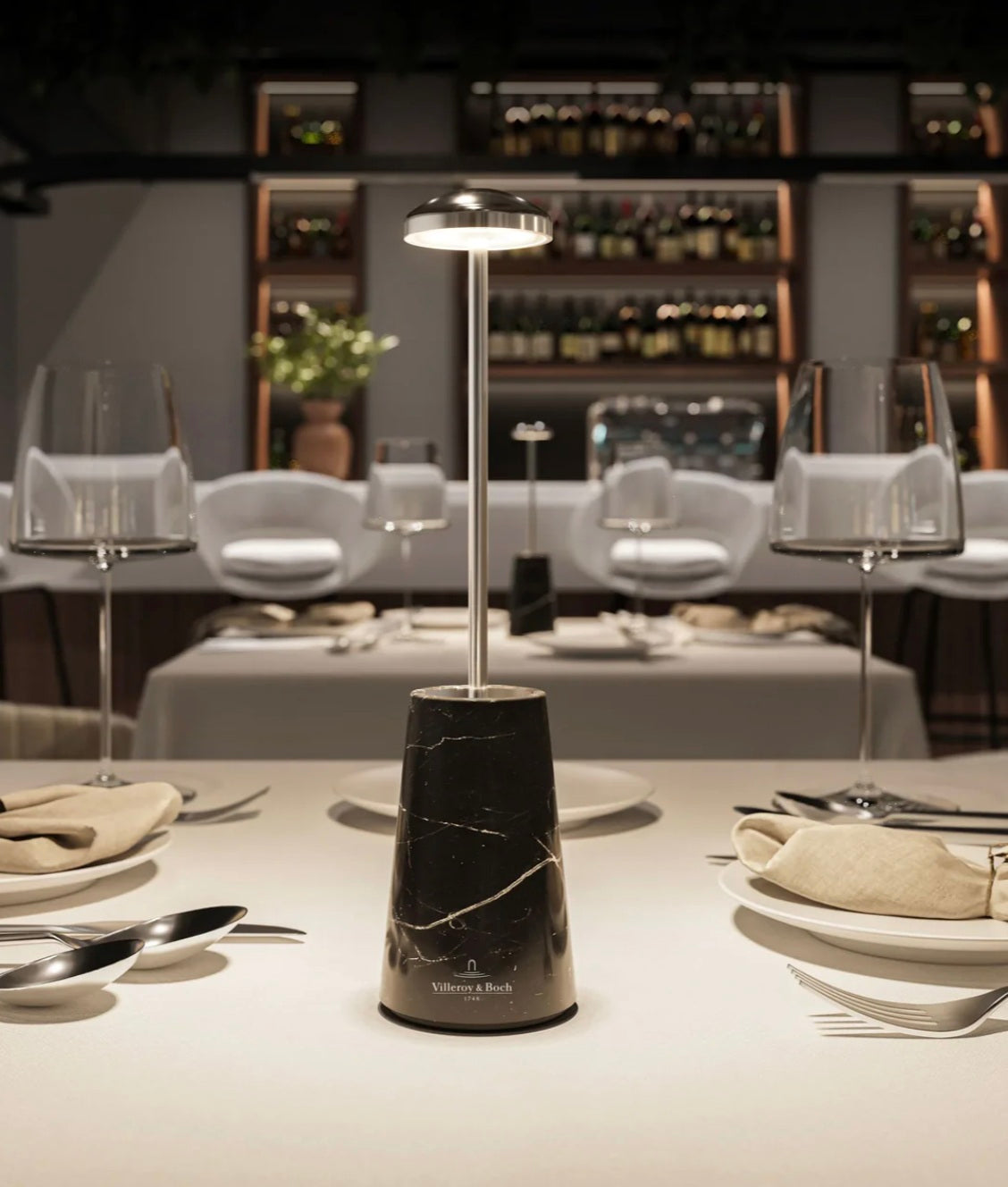 Villeroy & Boch Siena table lamp with black marble base and warm LED light, styled on an upscale restaurant table setting